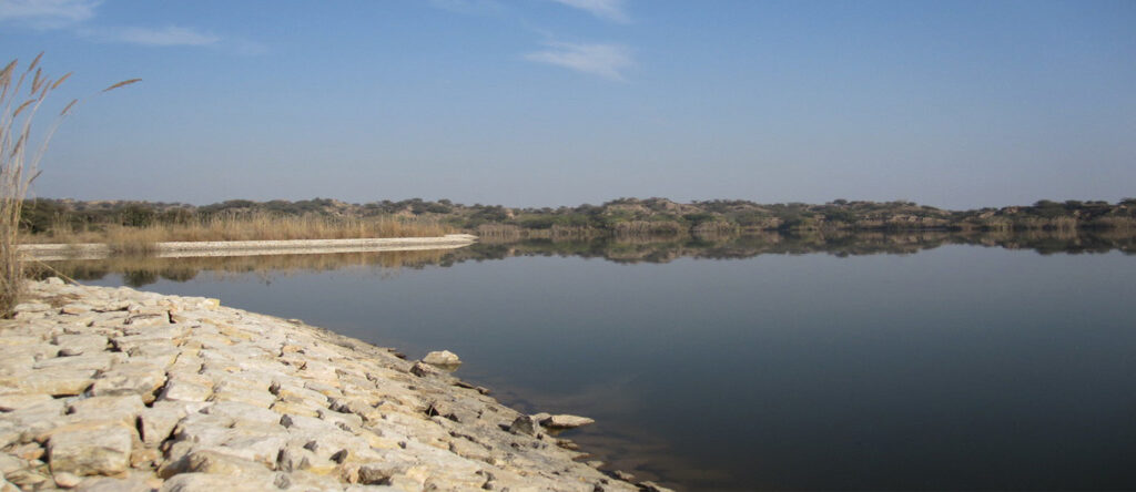 Aerial shot of Dharabi Lake near Chakwal, Punjab, showcasing its scenic beauty.