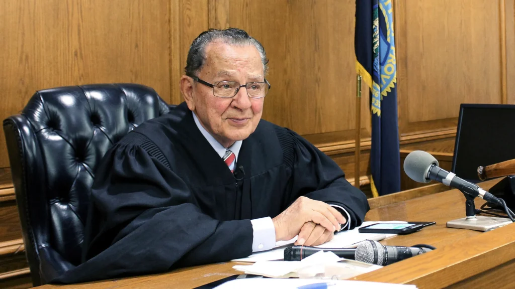 Judge Frank Caprio in his Providence courtroom, smiling warmly.