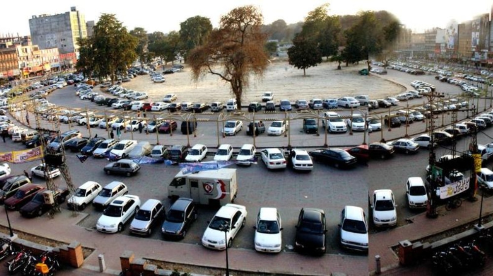 Busy street scene in Neela Gumbad, Lahore, with heavy traffic.