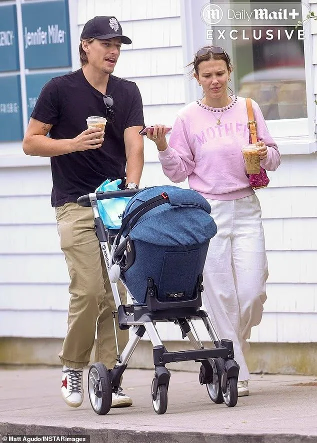 Millie Bobby Brown and Jake Bongiovi walking with adopted baby
