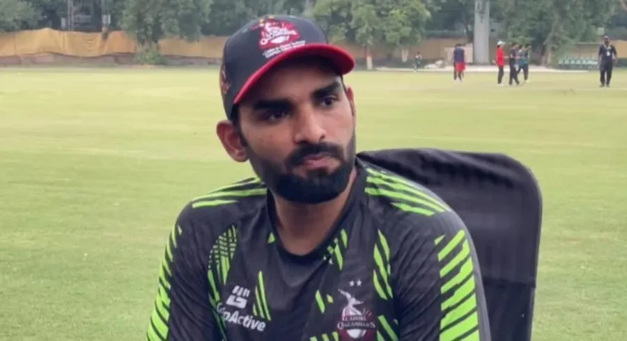 Asif Ali looking thoughtful or reflective on the cricket field.