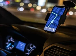 Smartphone scanning QR code on taxi in Islamabad for safety verification