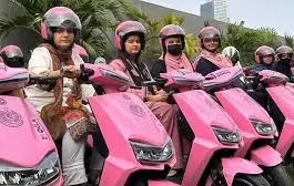 Woman riding free pink electric scooter in Sindh on Women's Day